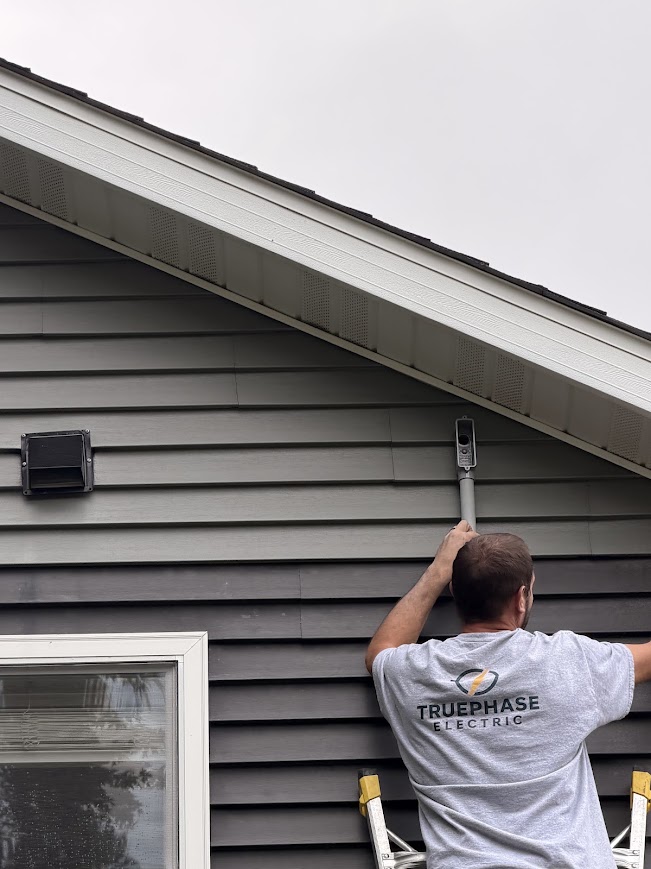 True Phase Electric electrician working on exterior wiring